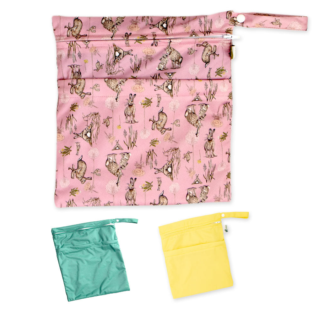 Little Lamb Wetbag Größe M im Design Moon Gazer, davor zwei kleine Nasstaschen in Grün und Gelb