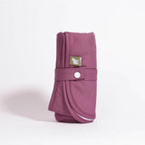Little Lamb Magic Foldaway Changing Mat in Aubergine (Dunkelviolett), aufgerollt mit Klettlasche und Tragegriff
